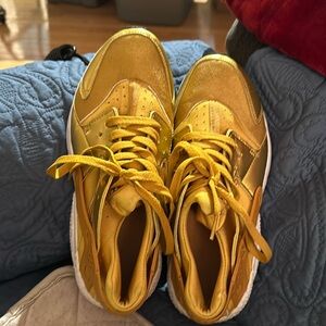 NIKE Hurrachis New Gold color. Slip on but have shoe strings for looks. Ladies.